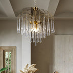 The clear-crystal version of this Clérachic chandelier hangs beside a white column, its drops catching light near a shuttered window.