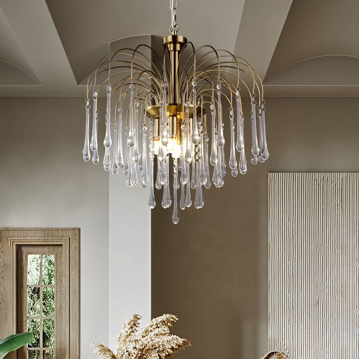 The clear-crystal version of this Clérachic chandelier hangs beside a white column, its drops catching light near a shuttered window.