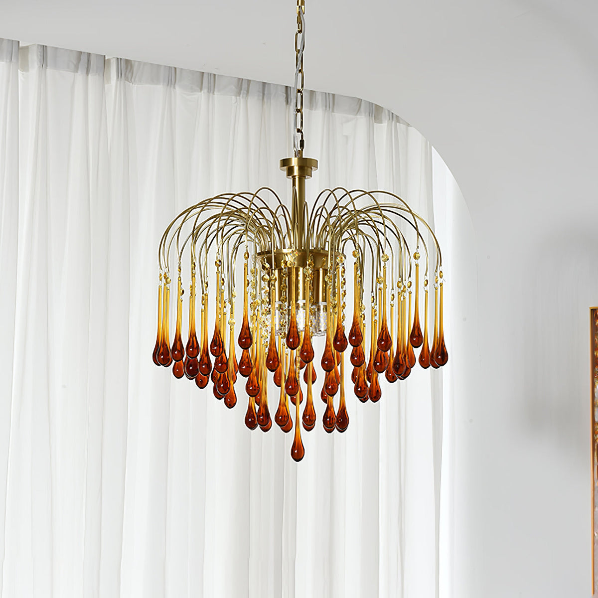 This Clérachic pendant's caramel crystal drops deepen from amber to red-brown, hung beside a sheer curtain.