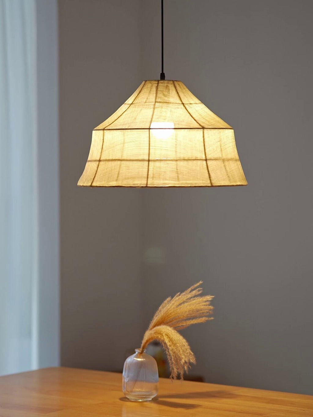 Close-up of the plaid-like woven texture on this faceted Clérachic pendant shade, with a pampas stem below.