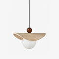 This Clérachic pendant balances a travertine sail on a walnut bead above a glowing opal glass globe.