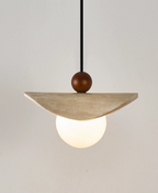 This travertine sail Clérachic pendant hangs from a slim black cord, its opal globe glowing softly.