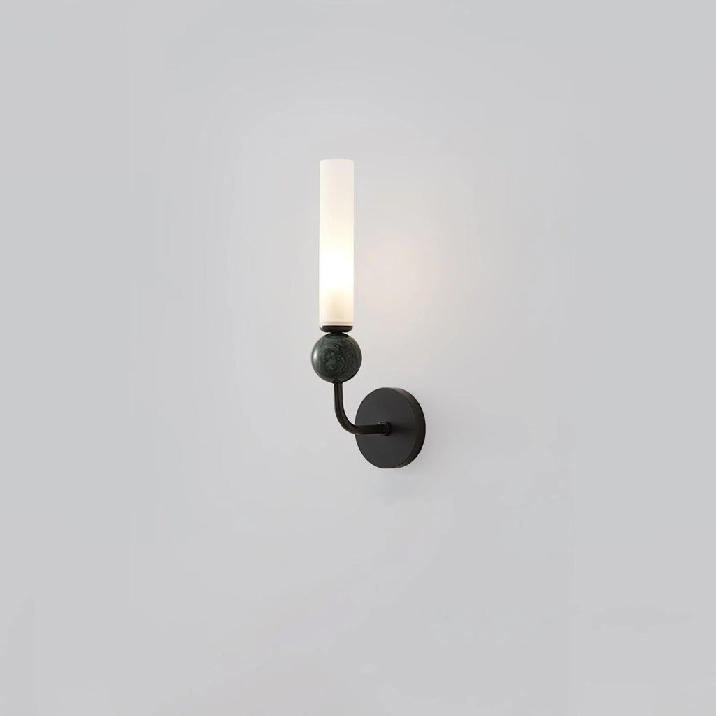 Seen at a gentle angle, this Clérachic black-arm wall sconce holds a black marble orb against a plain grey background.