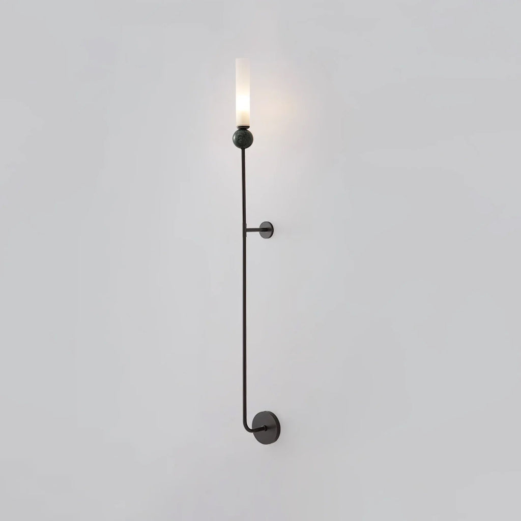 A tall Clérachic black vertical wall light shown full length against a plain grey background, lit at the top.