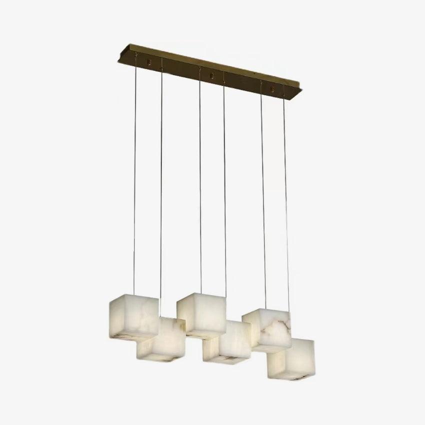 Small-scale studio view of the six-head Ivnoros chandelier, brass bar and six unlit alabaster cubes.