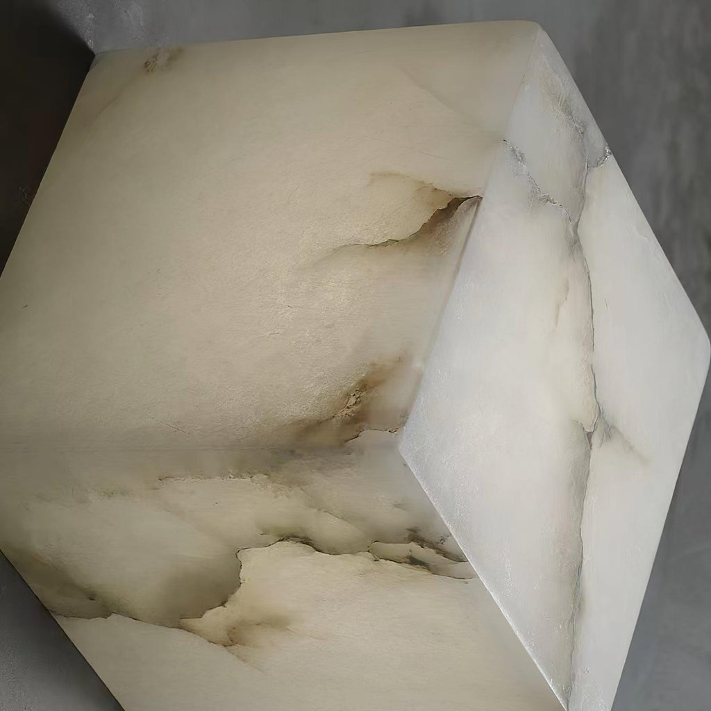 Close-up of one alabaster cube shade, showing the natural veining and soft translucency of the stone.