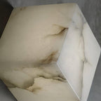 Close-up of one alabaster cube shade, showing the natural veining and soft translucency of the stone.