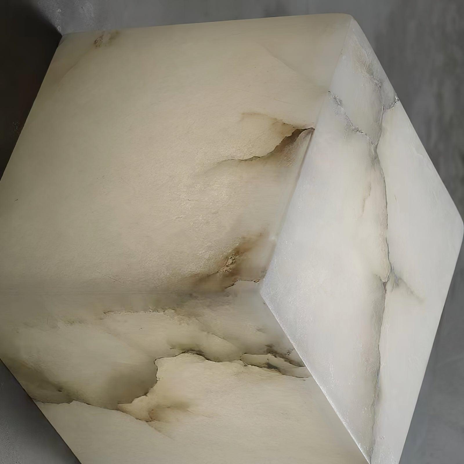 Close-up of one alabaster cube shade, showing the natural veining and soft translucency of the stone.