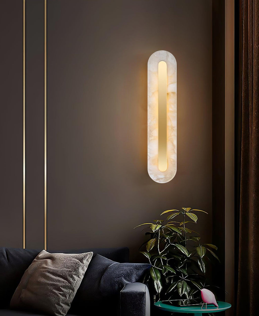 Tall alabaster wall sconce in white and brass with ambient glow