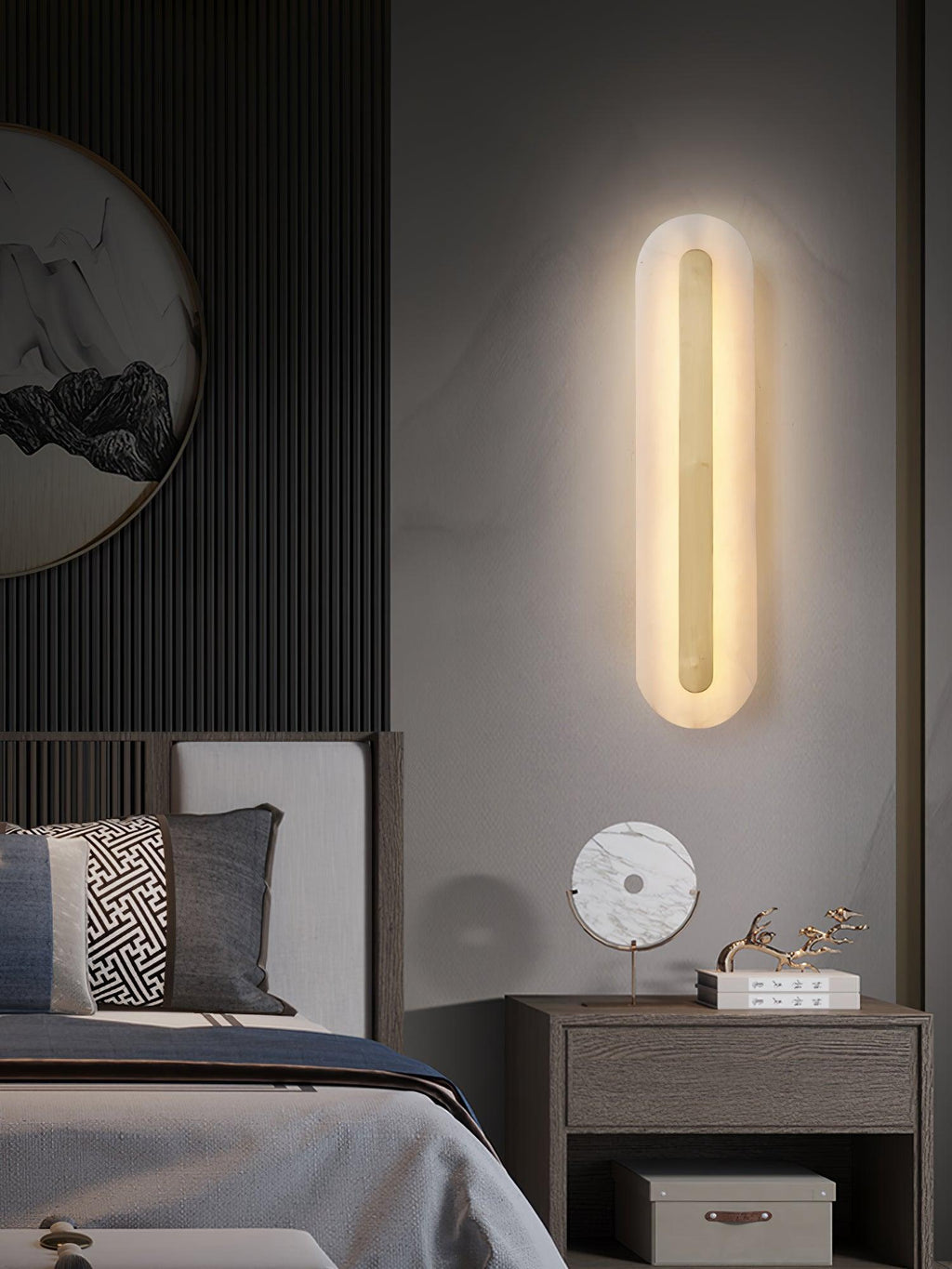 Brass and alabaster sconce illuminating a textured interior wall