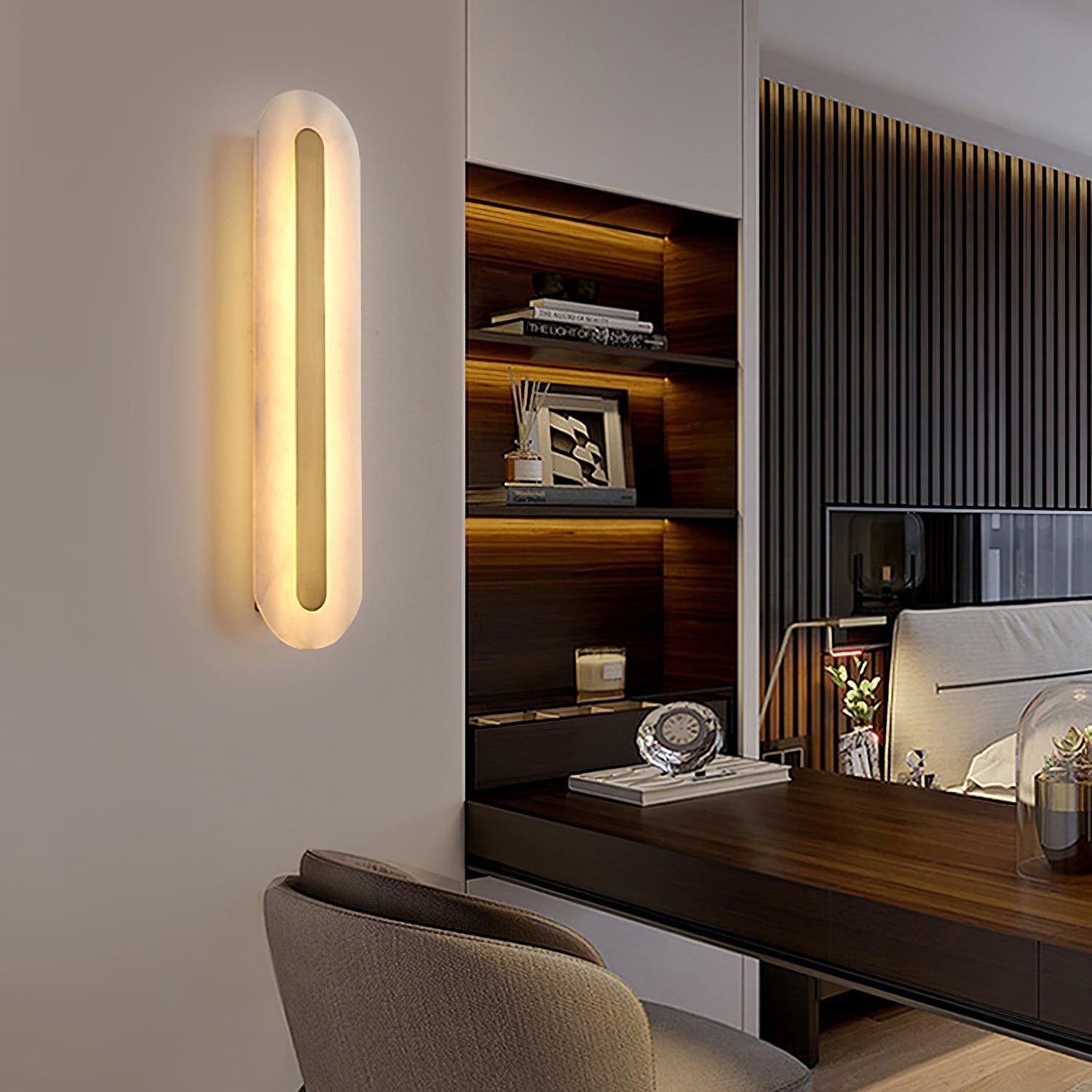 Clérachic selvia wall light seen at an angle on a white wall of a study, lit beside a walnut desk nook