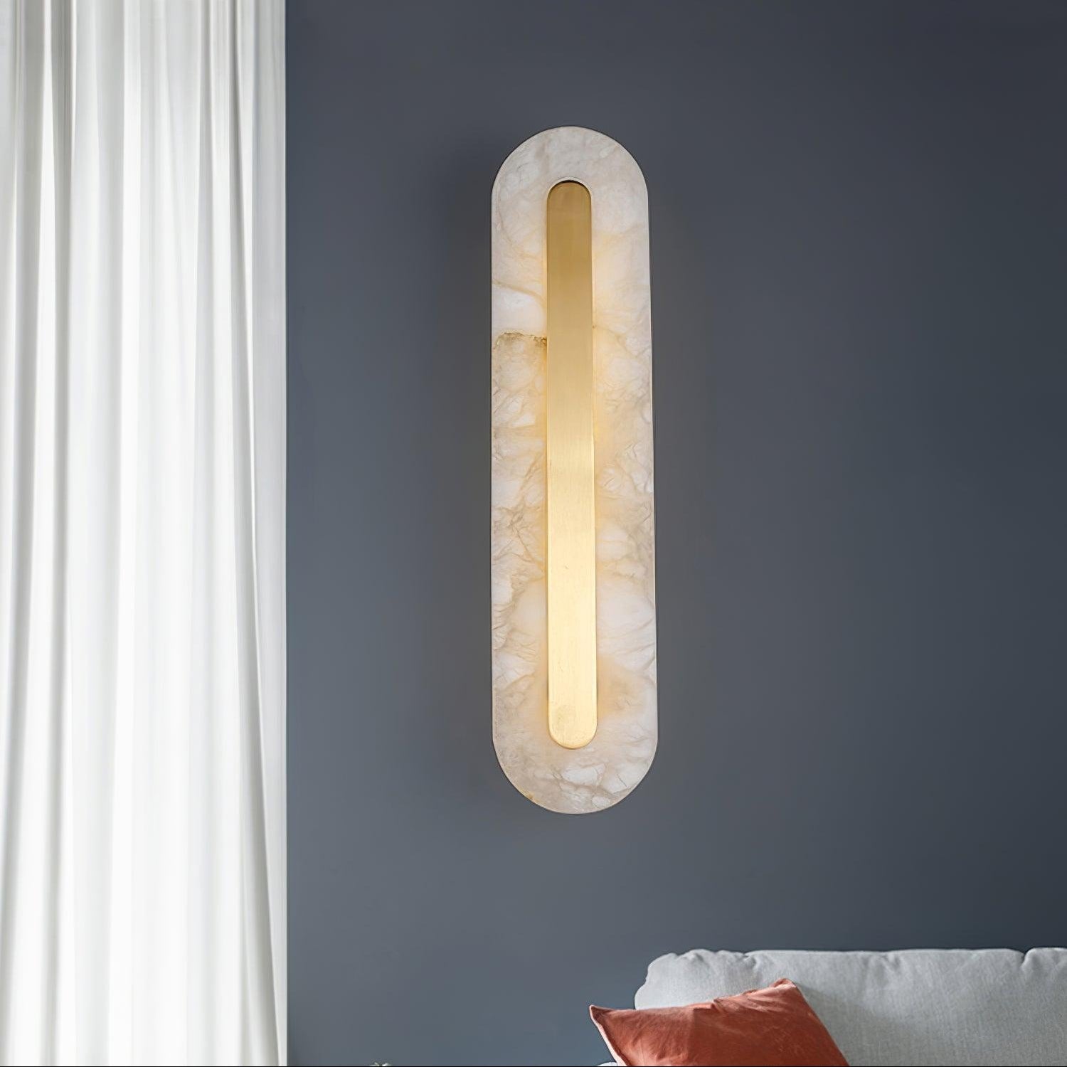 Clérachic selvia wall light on a deep blue-grey wall by a white curtain, alabaster veining clear in daylight
