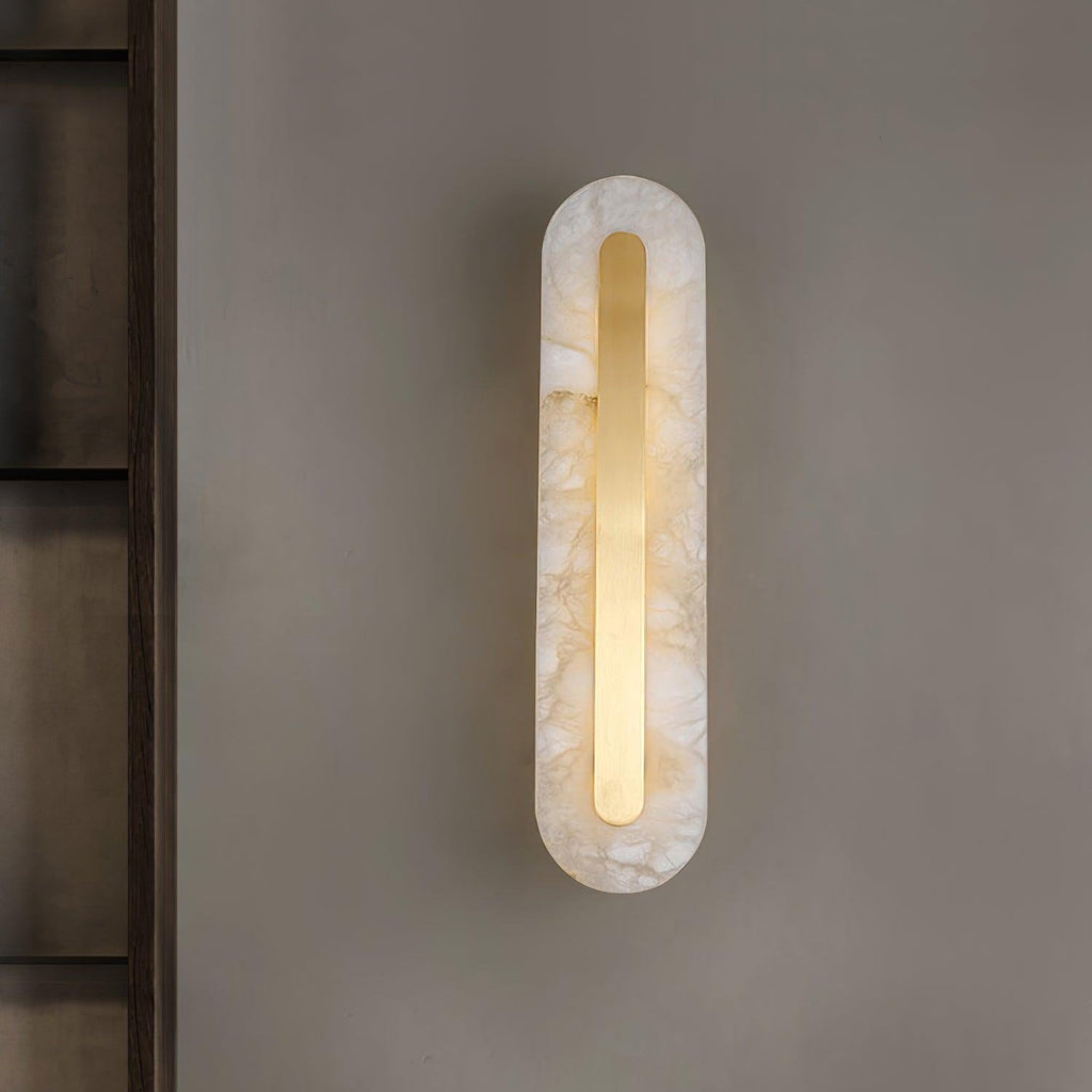 Clérachic selvia wall light lit and centred on a warm grey wall next to a dark shelving unit