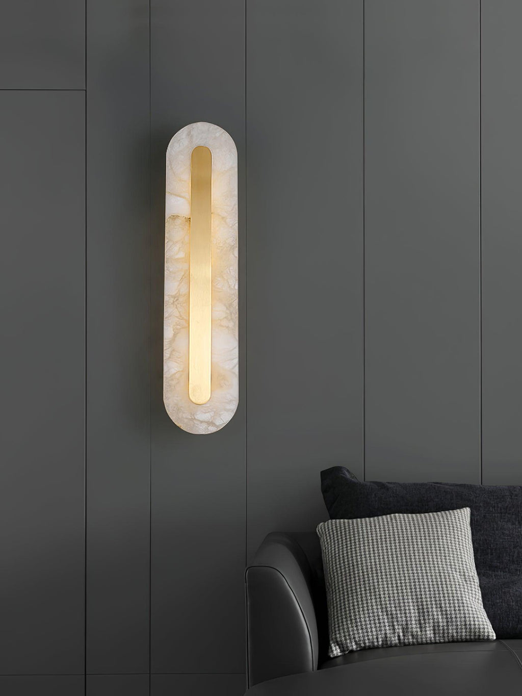 Brass-trimmed alabaster wall light glowing in a soft interior setting