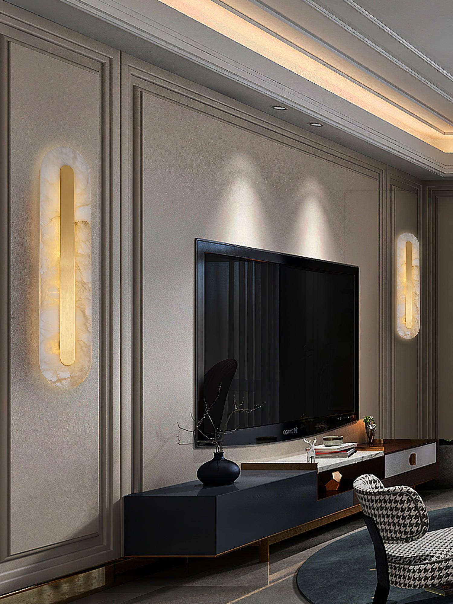 White alabaster and brass sconce mounted horizontally for a wide glow