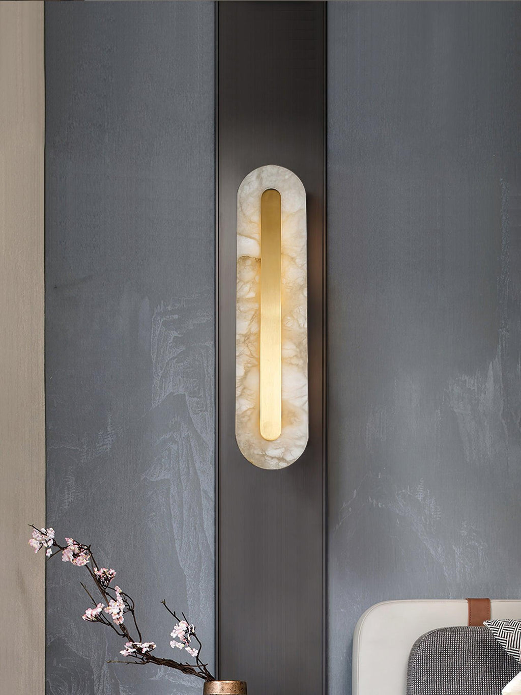 Alabaster stone sconce with brass canopy plate and warm light