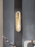 Alabaster stone sconce with brass canopy plate and warm light