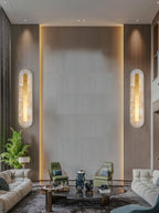 Soft glowing alabaster wall light against a neutral painted wall