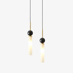 Two Clérachic pendant lights, one on a brass rod and one on black, each pair a dark marble sphere with a frosted glass cylinder.