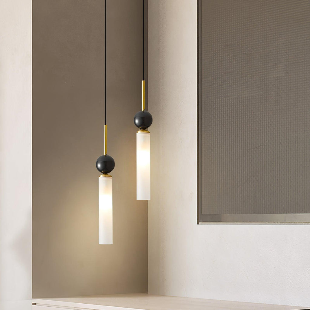 A close-up of two black Clérachic pendant lights against a recessed wall nook, cropped closer than the matching shot.