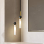 A close-up of two black Clérachic pendant lights against a recessed wall nook, cropped closer than the matching shot.