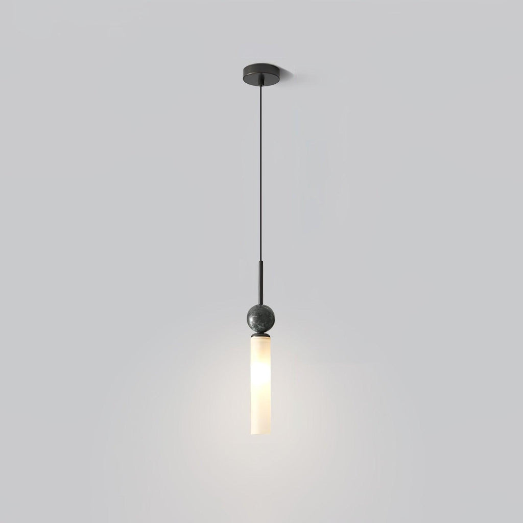 A studio shot of a single black marble Clérachic pendant light on a plain grey background, showing its straight ceiling stem.