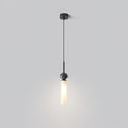 A single Clérachic pendant drops from a round black ceiling canopy, its frosted glass cylinder glowing against a soft grey backdrop.