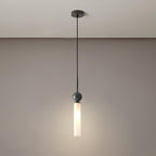 A studio shot of a single black marble Clérachic pendant light against a taupe gradient background, showing the ceiling mount.