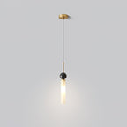 A studio shot of a single Clérachic pendant light on a plain background, showing its brass canopy, marble ball and frosted shade.