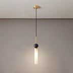 A studio shot of a single Clérachic pendant light on a white background, showing the black marble ball and cylinder shade up close.