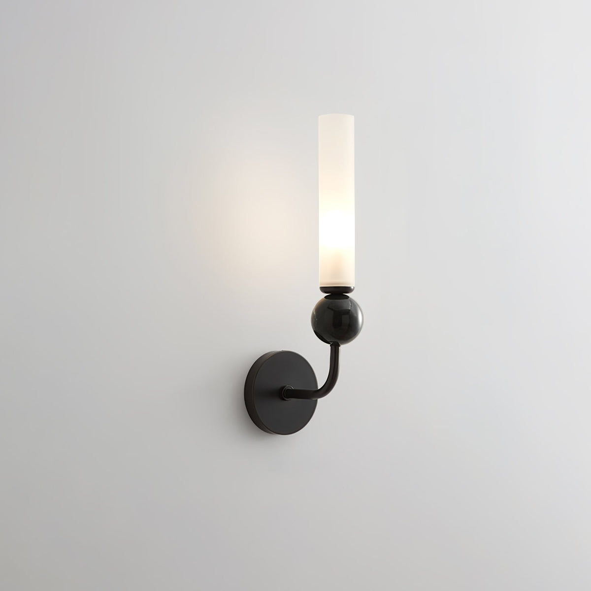 A closer angle brings this Clérachic black-arm wall sconce's black marble orb forward against a plain grey background.