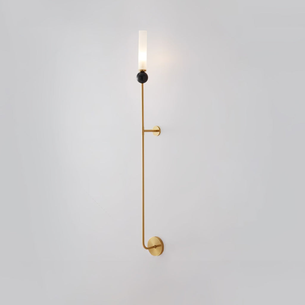 Seen from a slightly different angle, this tall Clérachic brass vertical wall light stands full length on plain grey.