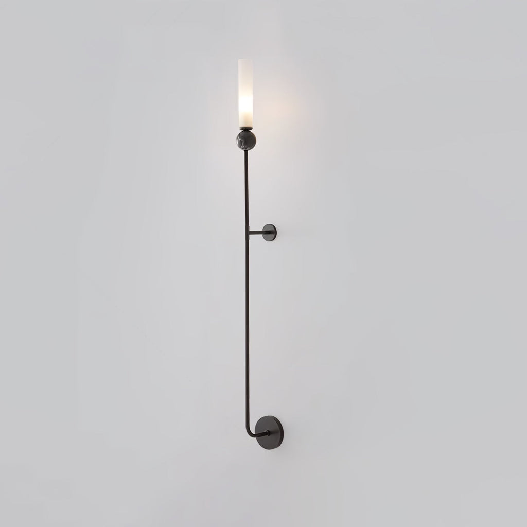A tall Clérachic black vertical wall light glows at the top, standing full length against a plain grey background.