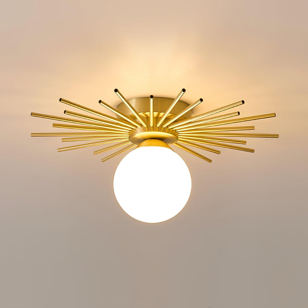 Set against a dusty mauve backdrop, this Clérachic ceiling light shows its full brass spread and globe.