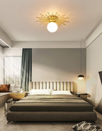 This Clérachic ceiling light glows in a bedroom with sage curtains, a quilted headboard and a hanging pendant nearby.