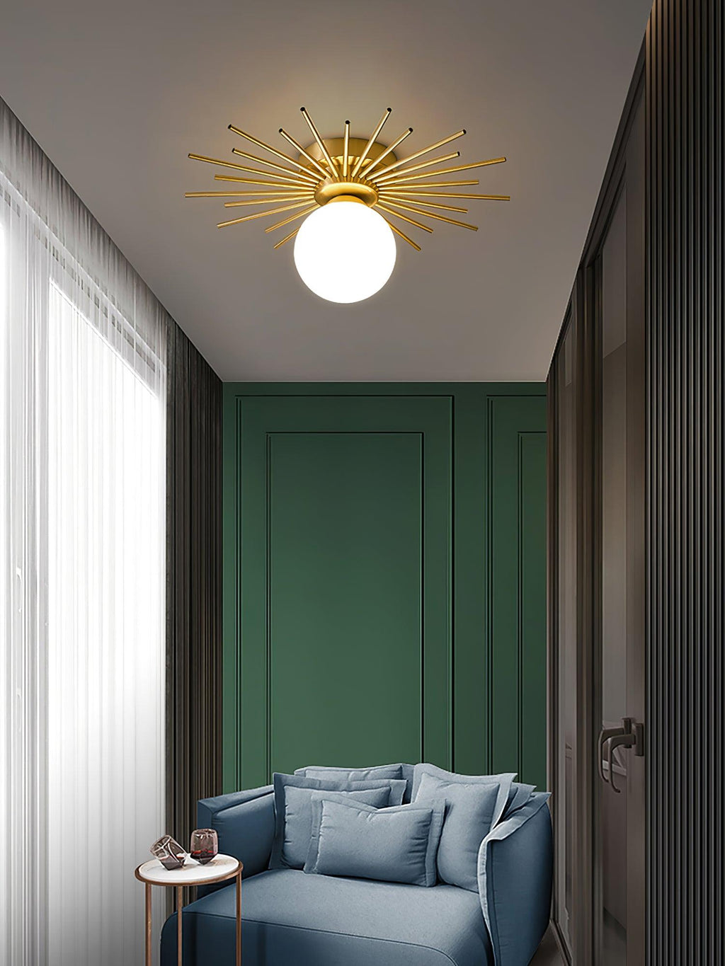 Green wall panels and a blue armchair sit beneath this Clérachic ceiling light in a bright hallway.