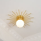 From an upper corner, this Clérachic ceiling light shows its full brass spread above ornate crown moulding.
