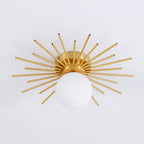 Angled product shot of this Clérachic ceiling light, brass rods radiating from around the frosted globe.