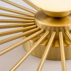Close view of the brass rods radiating from the mounting disc of this Clérachic ceiling light.