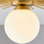 Close view of the frosted glass globe on this Clérachic ceiling light, its brass canopy visible above.
