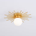 Front-on against plain grey, this Clérachic ceiling light shows the globe centred beneath its brass rays.