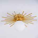 Close angled shot on grey of this Clérachic ceiling light, its brass spikes catching the studio light.