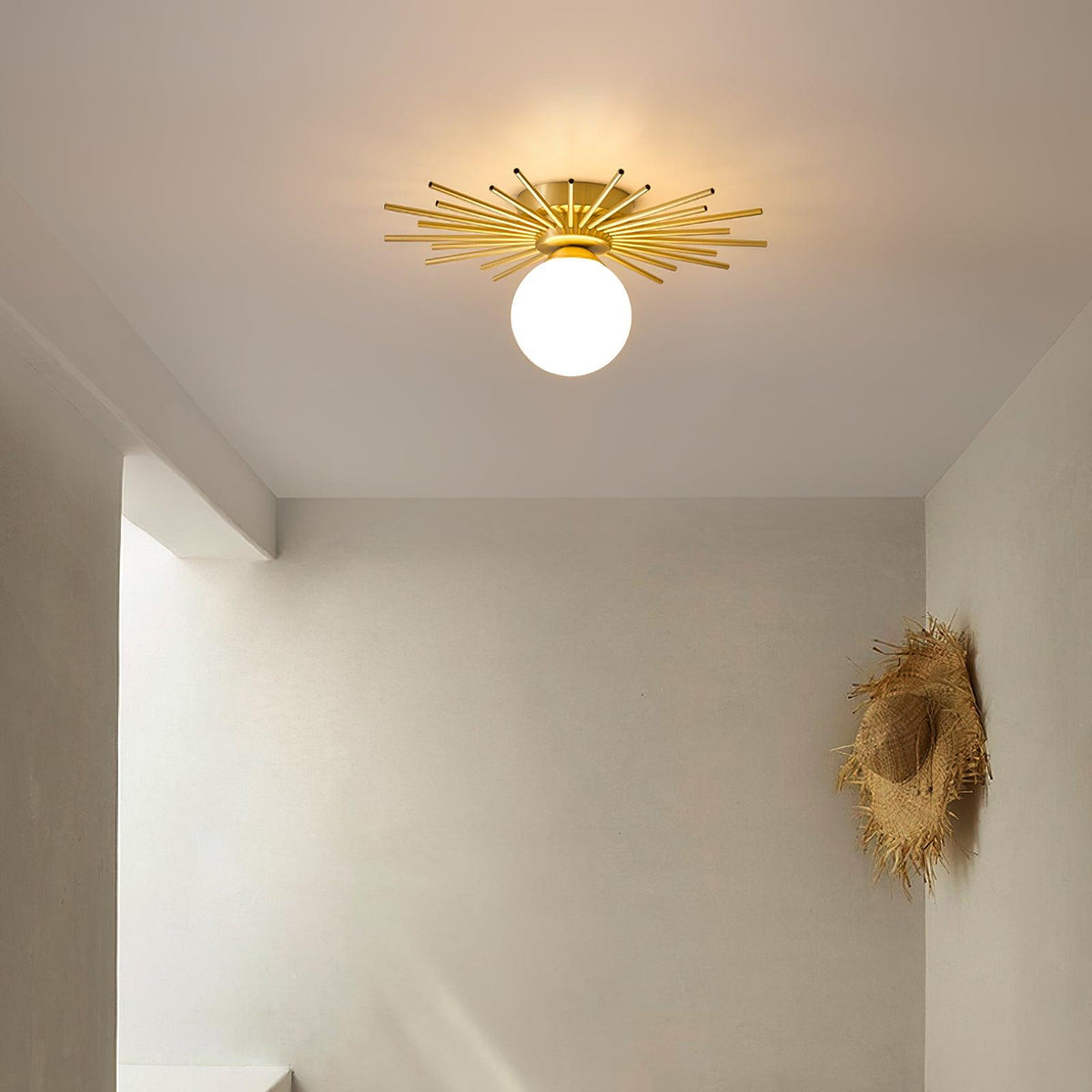 Mounted above a plain doorway, this Clérachic ceiling light warms the hallway below with a soft glow.