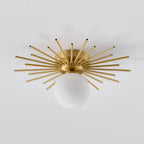 Side angled shot on grey of this Clérachic ceiling light, the frosted globe sitting beneath its rays.