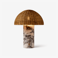 Rattan dome-shade table lamp with a white and grey marble base from Clérachic, photographed alone on white.