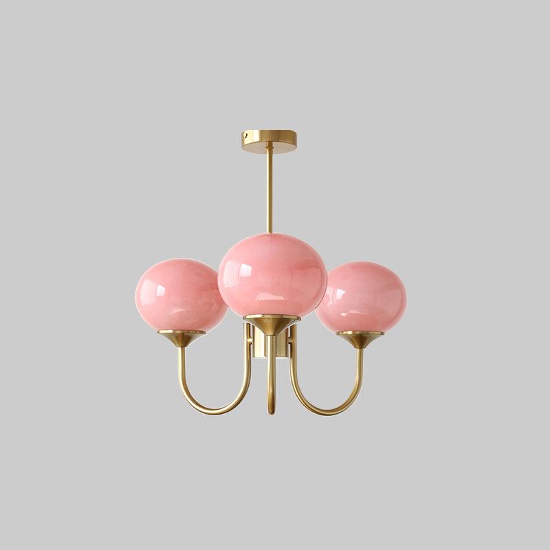 Marshmallow chandelier with rounded glass shades hanging over a dining table