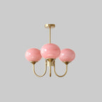 Marshmallow chandelier with rounded glass shades hanging over a dining table