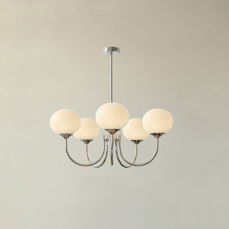 Marshmallow chandelier detail with rounded glass shades lit warmly
