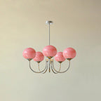Glass-shade chandelier shown lit against a soft neutral backdrop