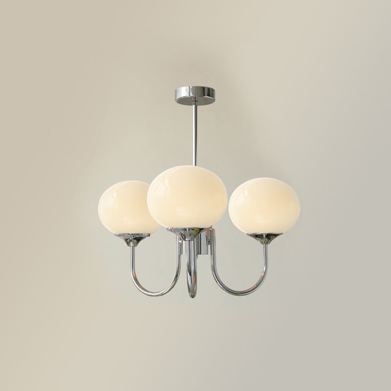 Glass-shade chandelier casting a warm glow in a living room